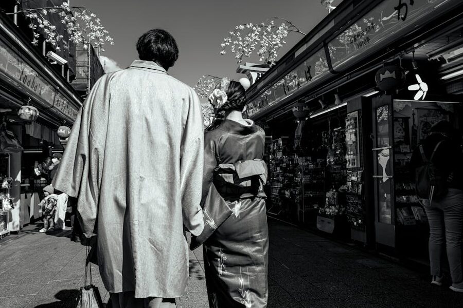 Couple in traditional kimono walking through Taito City in Asakusa, Tokyo