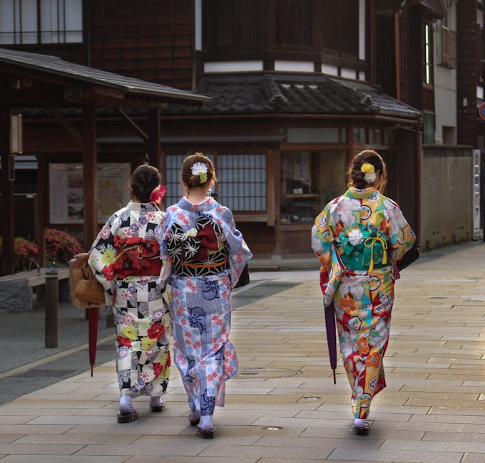 Three women wearing colorful kimonos at a Japanese festival