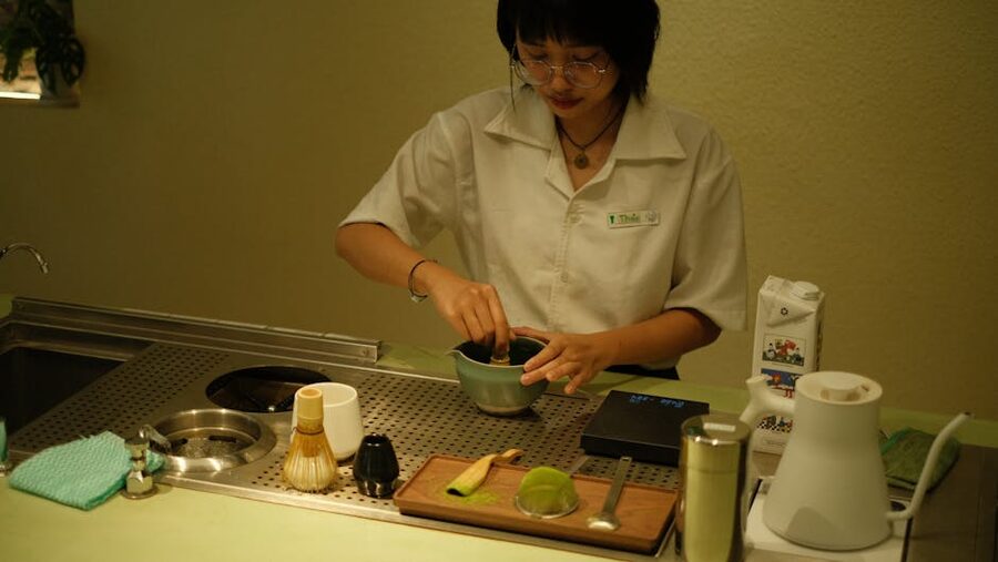 A teacher preparing matcha in a modern Tokyo teahouse