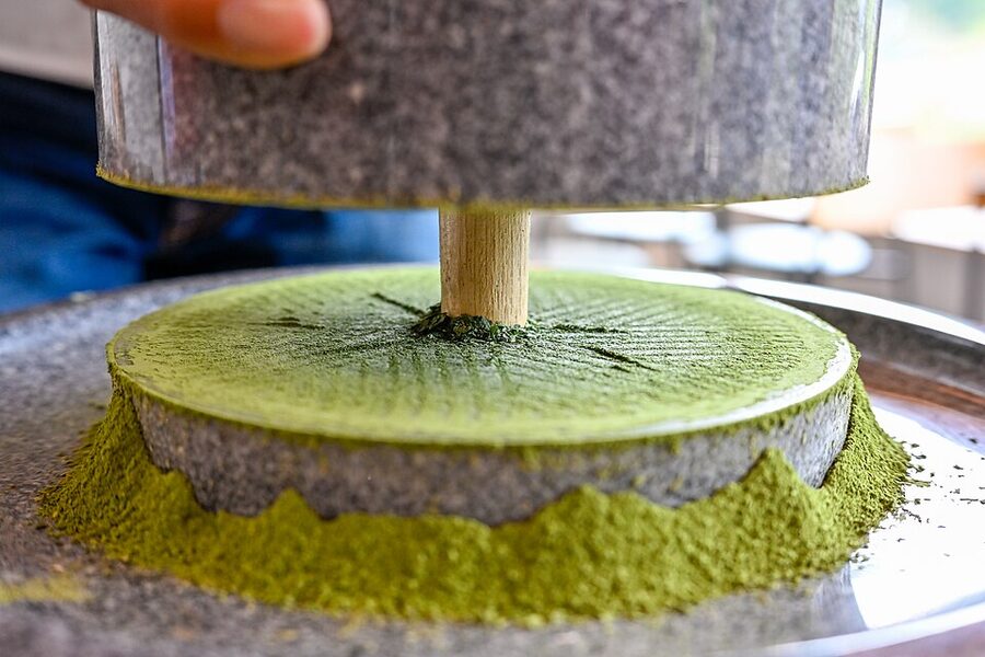 Traditional stone mill grinding tencha leaves into matcha powder