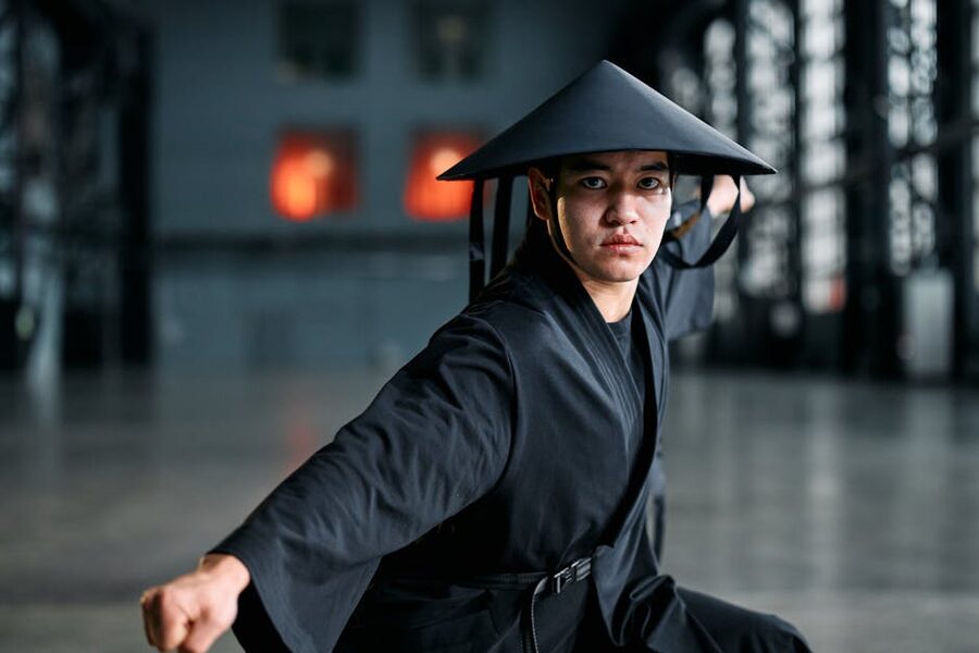 Martial artist in black kimono practicing a stance