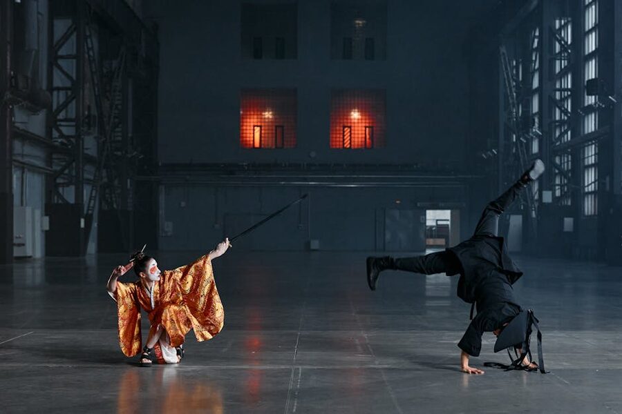 Two people practicing sword duel in traditional Japanese costume