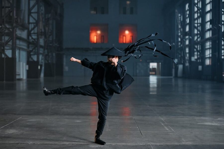 Ninja cosplayer performing a high kick