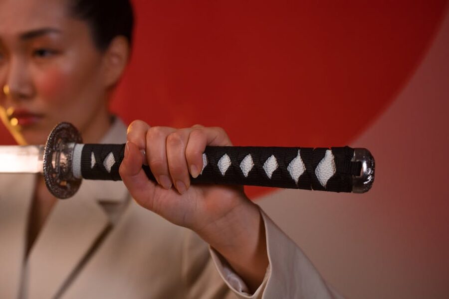 Close-up of hands gripping a katana sword
