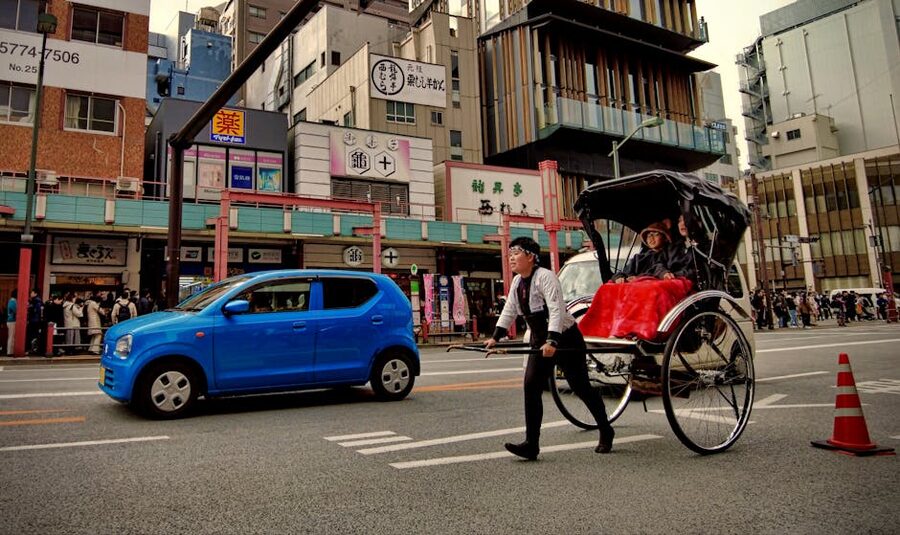 Rickshaw pulling tourists through Asakusa Tokyo
