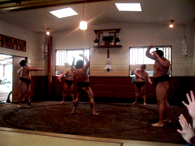 Sumo wrestlers facing each other at practice in a heya