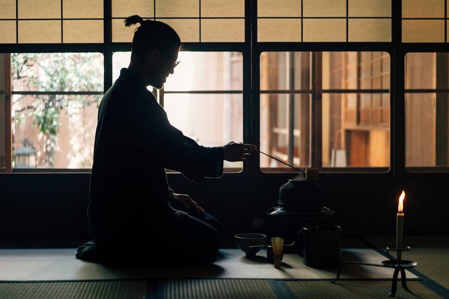 Silhouette of person performing a traditional Japanese tea ceremony
