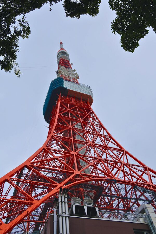 Tokyo Tower framed by surrounding buildings in Minato City during daytime