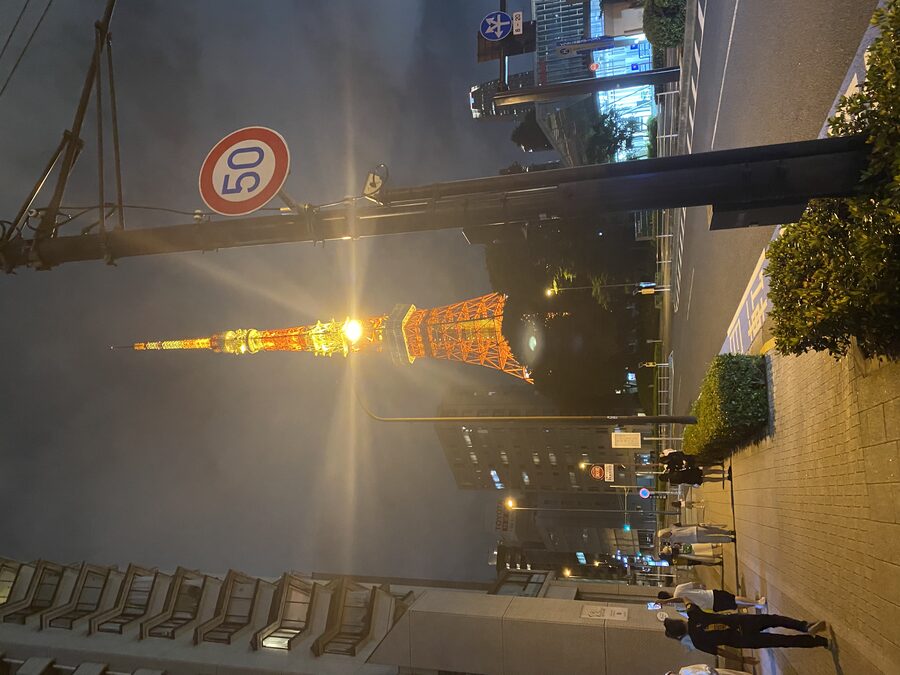 Tokyo Tower glowing with warm light against the dark night sky