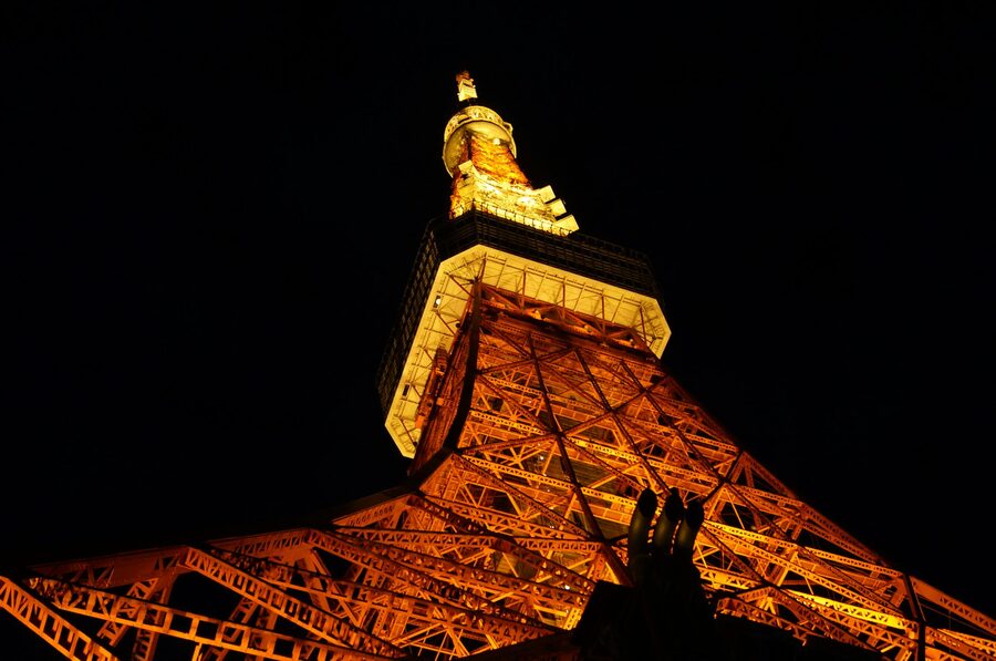 Tokyo Tower glowing orange against the night sky in Tokyo