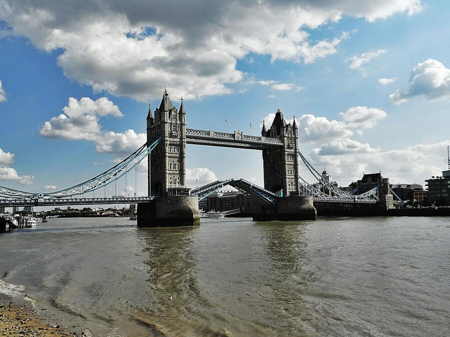 Tower Bridge bascules raised blue sky London