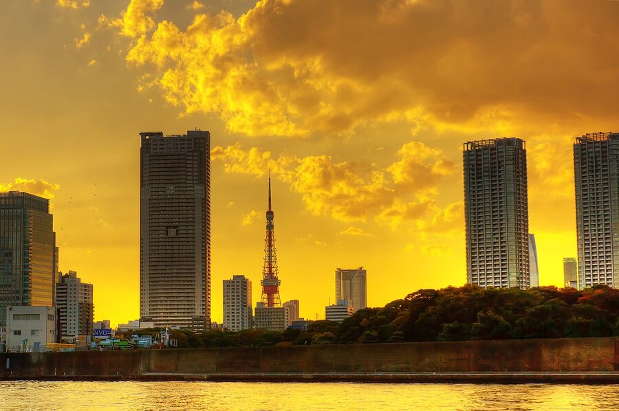 Tokyo Tower silhouetted against a sunset sky with city skyline