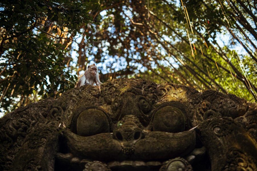 Monkey on an ornate sculpture in Ubud Monkey Forest