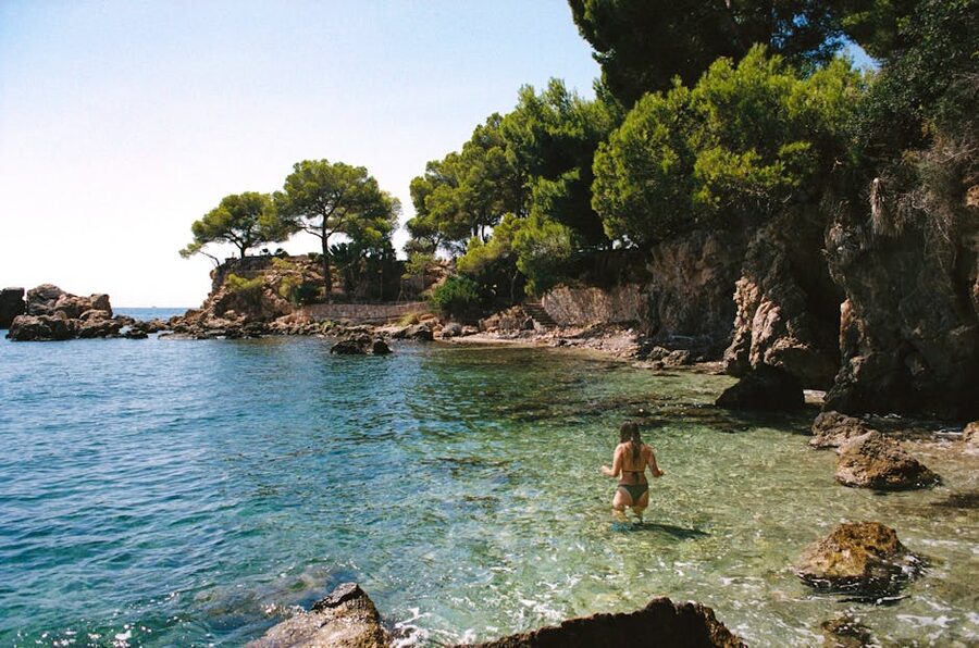 Swimmer on rocky Mediterranean coast