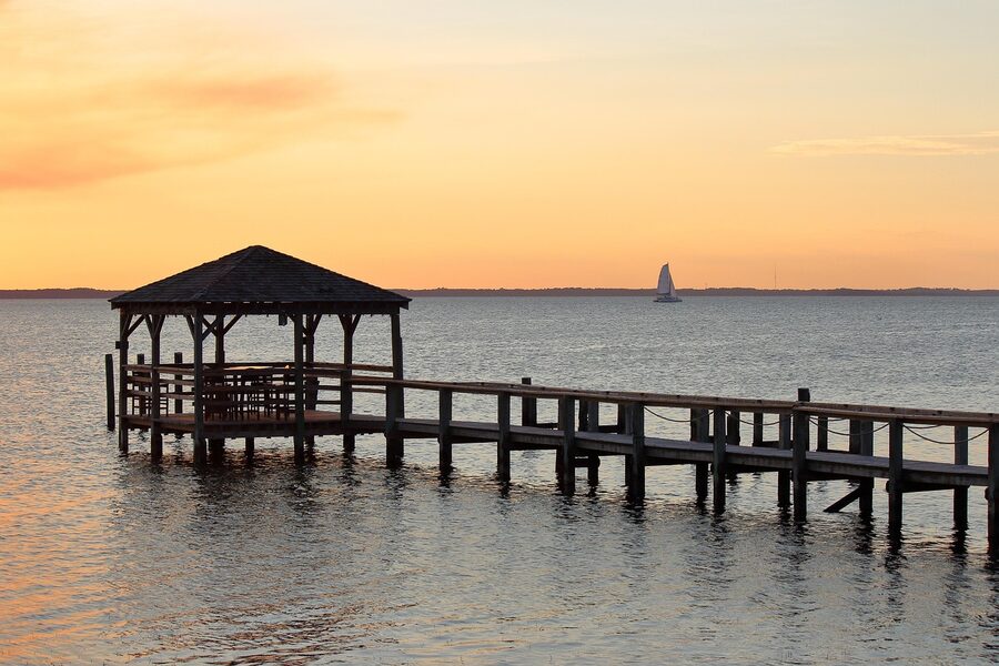 Catamaran at sunset on calm water