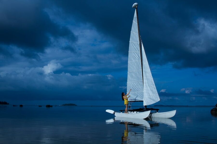 White catamaran on serene ocean during twilight