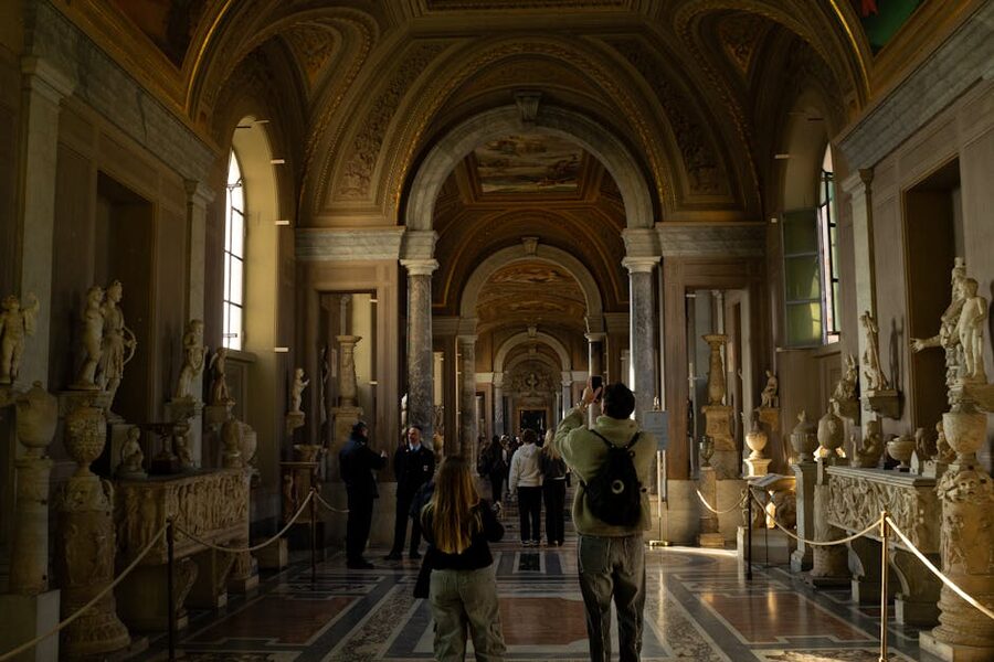 Visitors in Pio Clementino sculpture hall at Vatican Museums