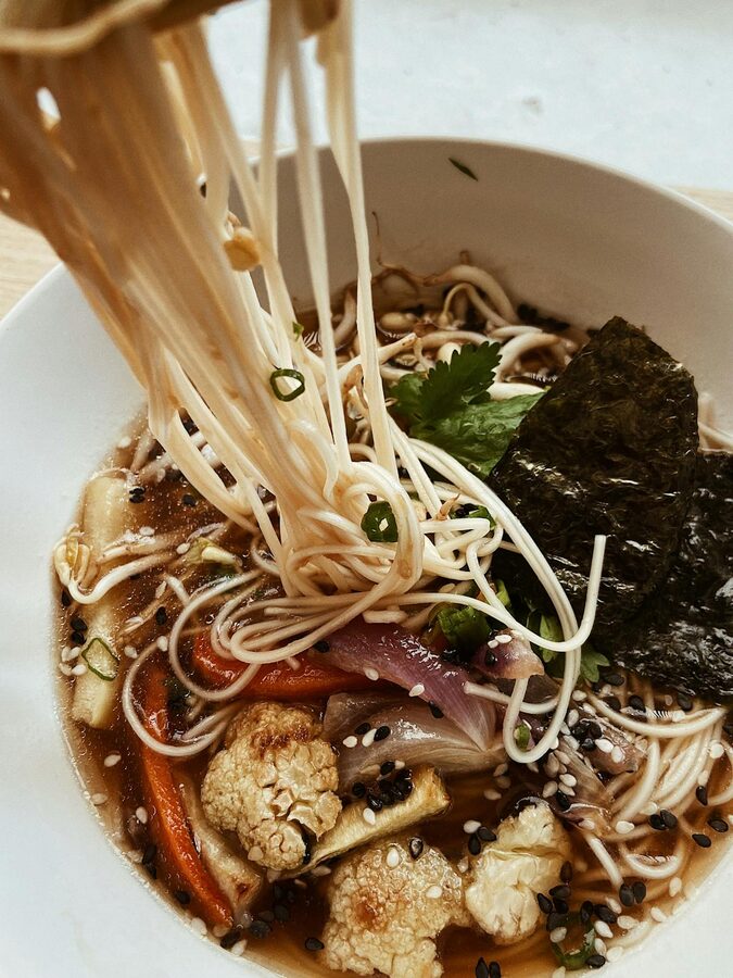 Bowl of vegan ramen with noodles vegetables and broth