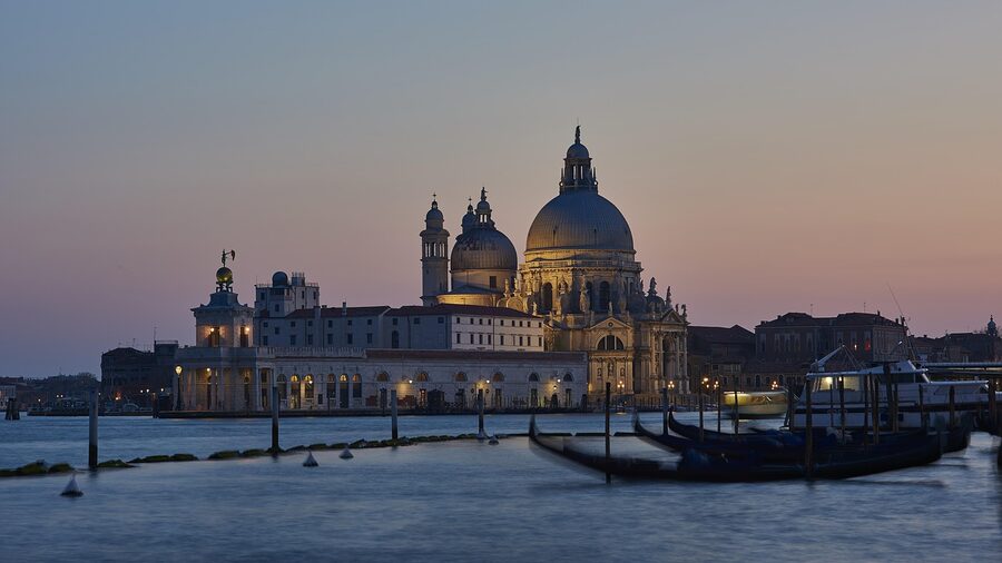 Gondola at sunset over Venice lagoon