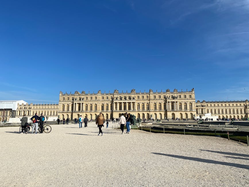 Tourists outside Versailles Palace on a sunny day