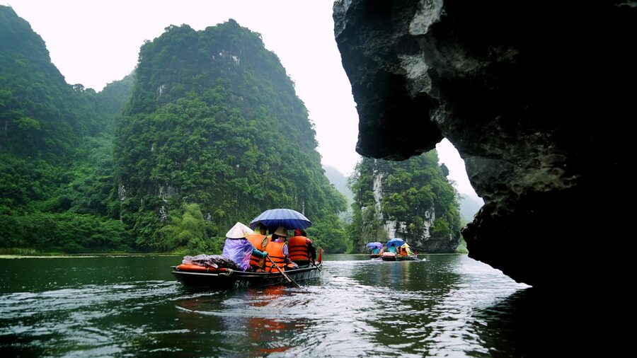Green Ha Giang valley surrounded by steep limestone cliffs