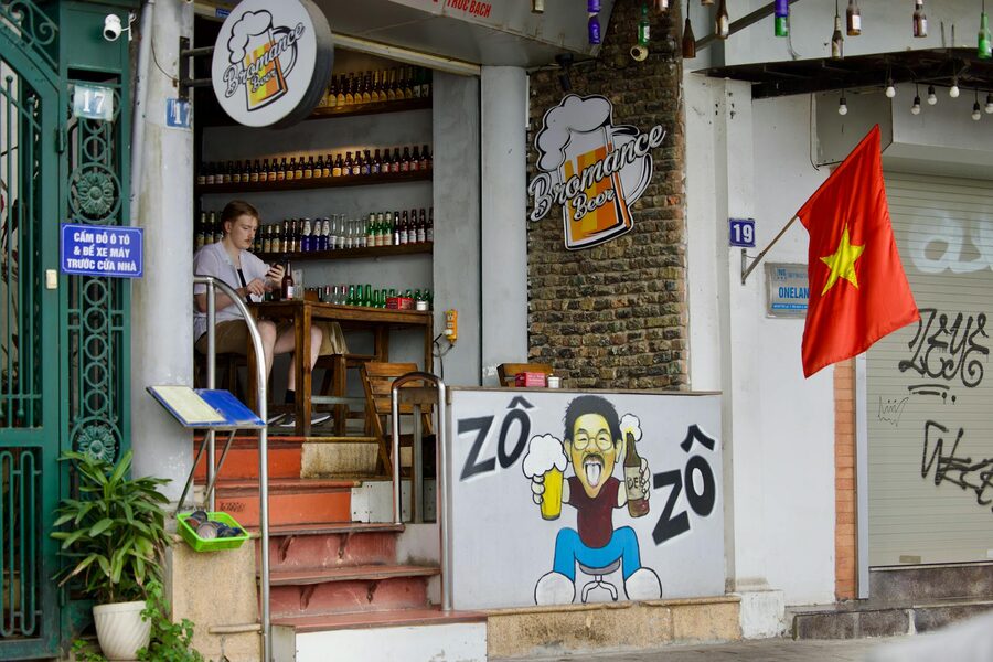 Street bar scene in Vietnam with bottles and warm lighting