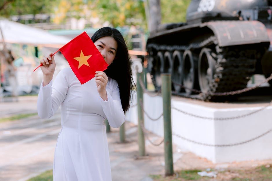 Woman near a Vietnam War-era tank at a memorial site