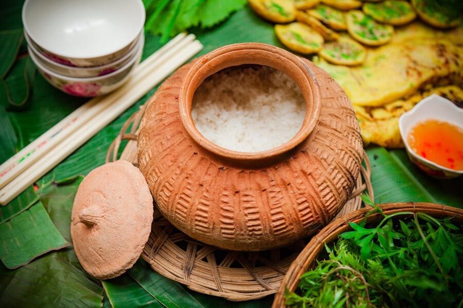 Traditional Vietnamese clay pot meal with herbs
