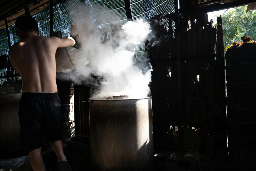 Man cooking traditional Vietnamese food at an open market