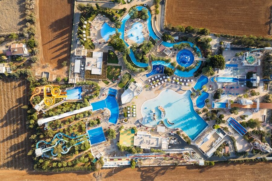 Aerial view of busy water park with multiple slide structures