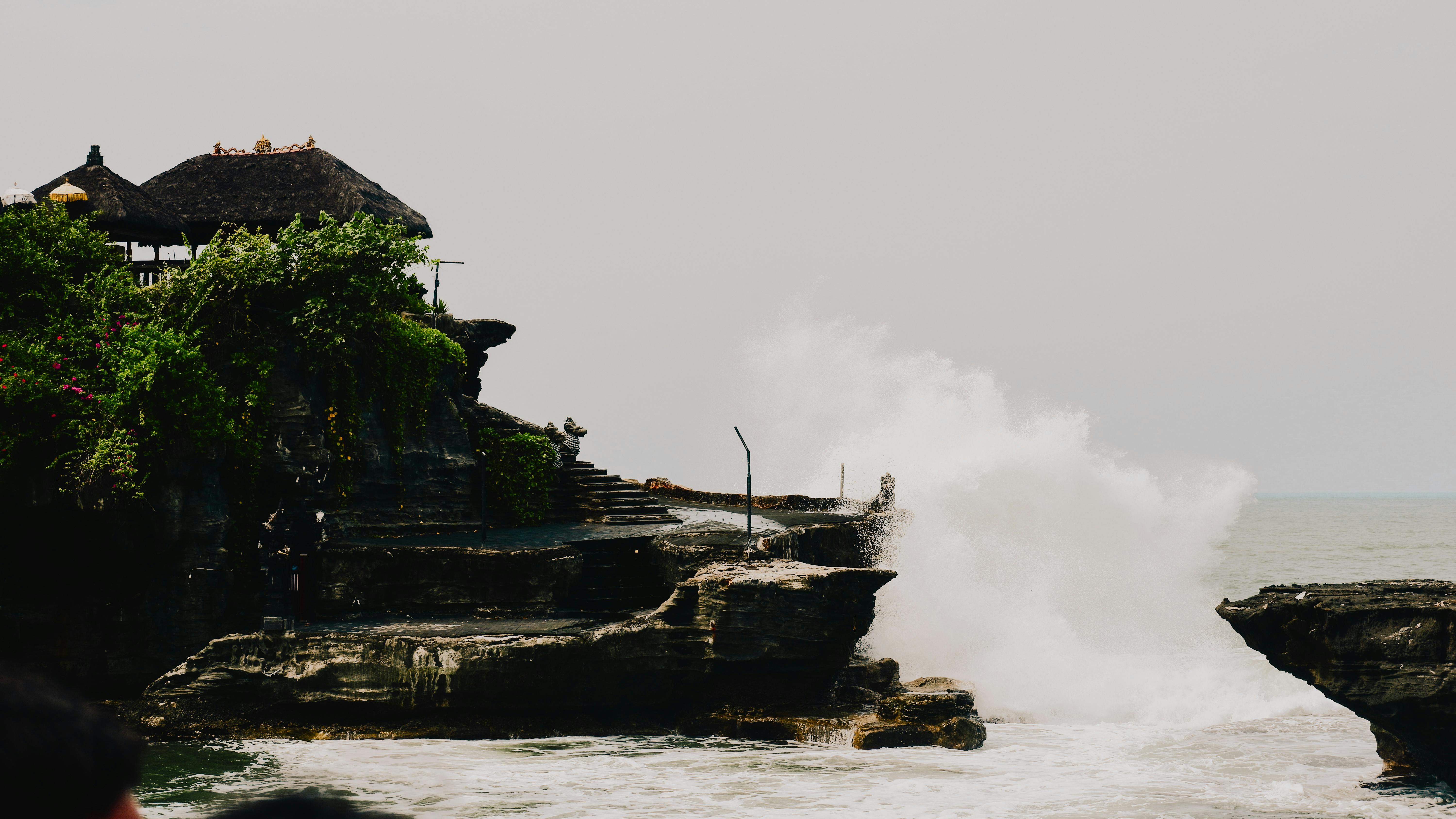 Dramatic waves crashing against the cliffs around Tanah Lot Temple