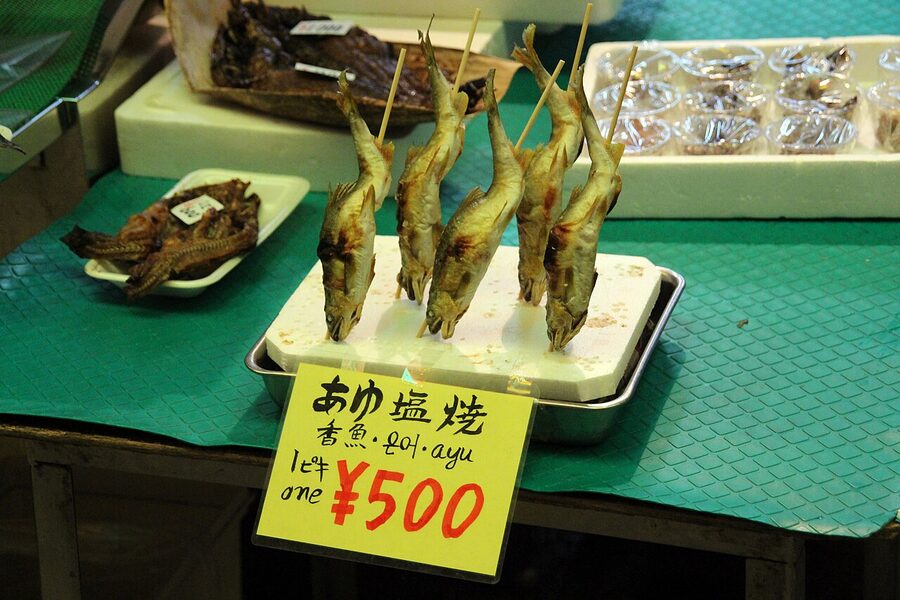 Nishiki Market covered shopping street in Kyoto filled with food stalls and shoppers