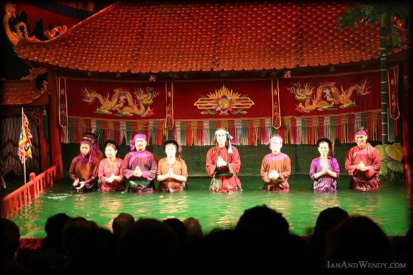 Colorful water puppets on the surface of the pool stage during a performance at Thang Long Theatre