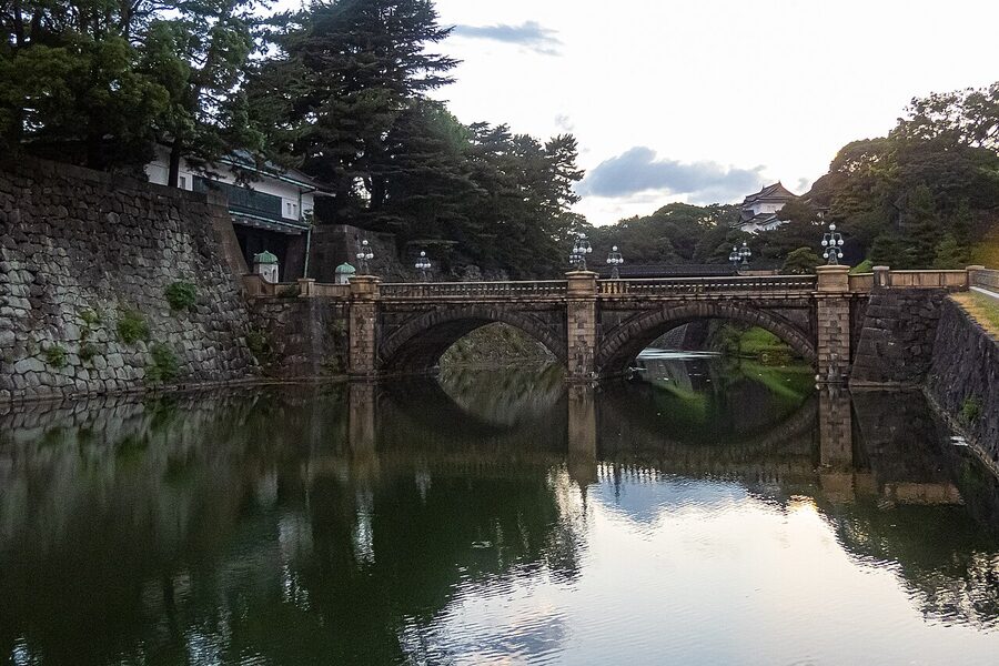The Seimon Ishibashi stone bridge at the Tokyo Imperial Palace at dusk with warm lighting