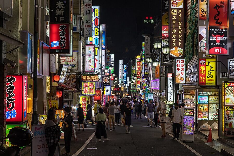 Bright neon street signs in Kabukicho Shinjuku at dusk