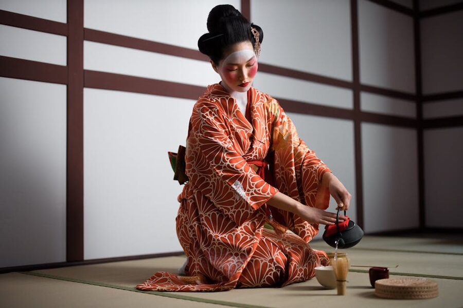 Woman performing Japanese tea ceremony wearing kimono