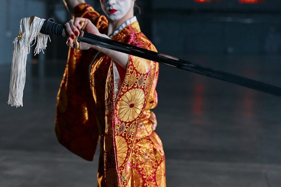 Woman in ornate kimono holding a katana