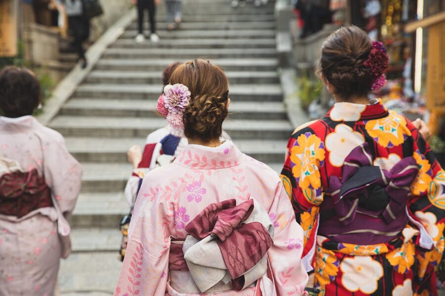 Women in kimonos walking on stone staircase in Kyoto