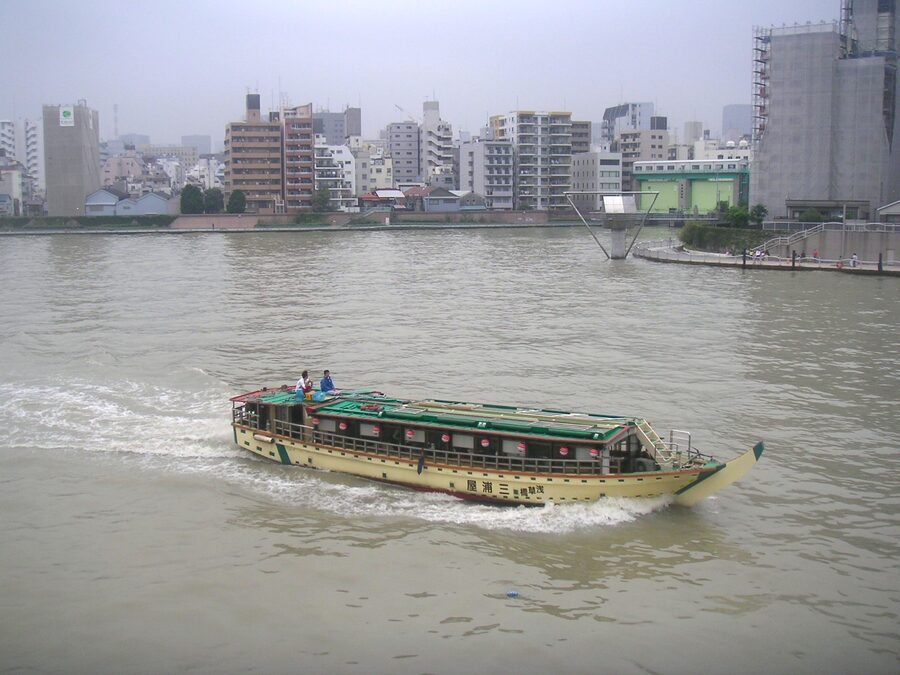 A yakatabune traditional pleasure boat cruising on a Tokyo waterway