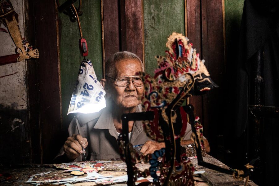 Yogyakarta craftsman carving wayang puppet