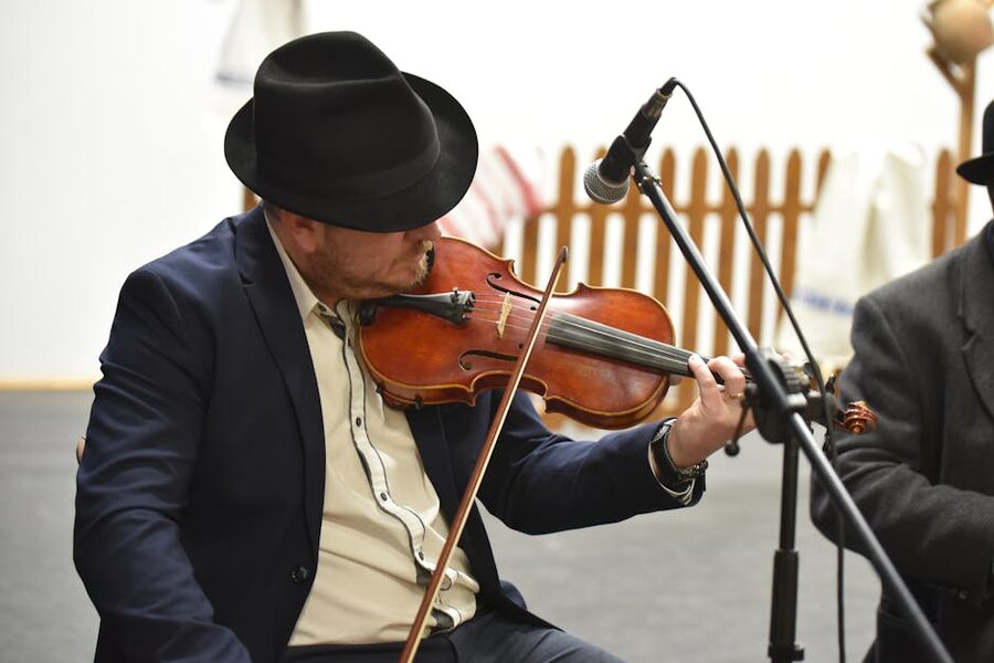 Hungarian musician in traditional attire playing violin
