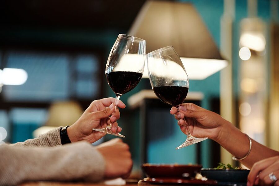 Couple toasting with red wine glasses at a romantic dinner