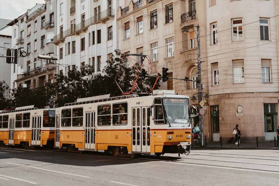 Budapest classic yellow tram on city street with historic buildings