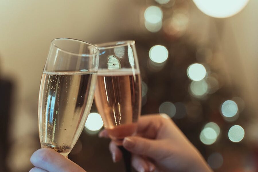 Clinking champagne glasses in a celebratory toast