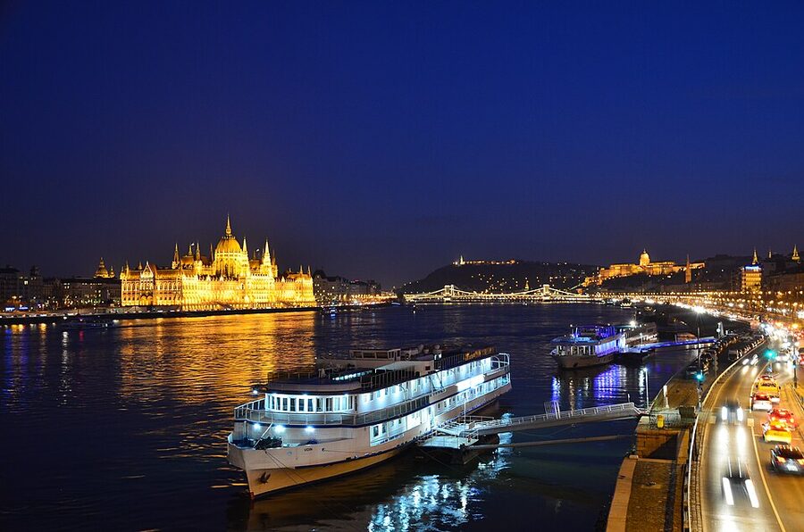 Hungarian Parliament Building lit up at night seen from the Danube