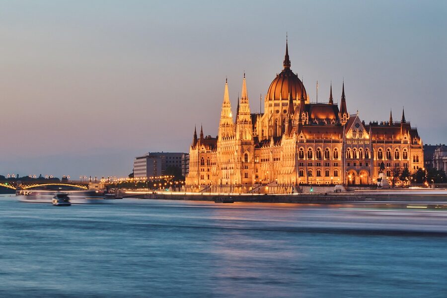 Hungarian Parliament Building glowing on the Danube at night