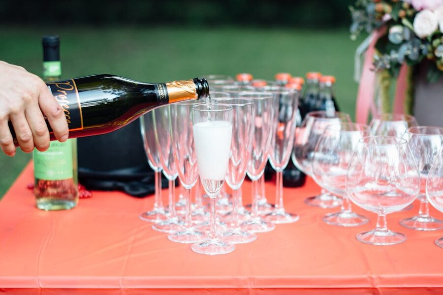 Prosecco being poured into champagne flutes