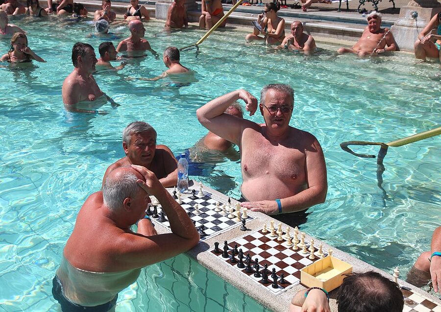 Chess players in the outdoor Szechenyi pool with marble boards