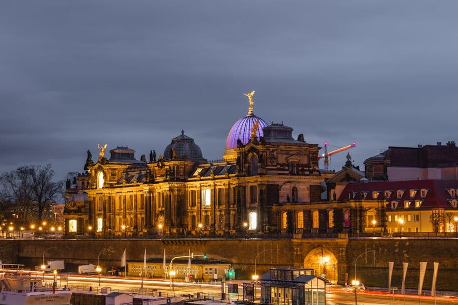 Dresden Academy of Fine Arts illuminated at night with tenement buildings