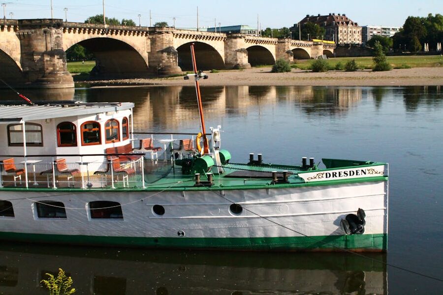 Boat on the Elbe with Dresden historic bridge in the background